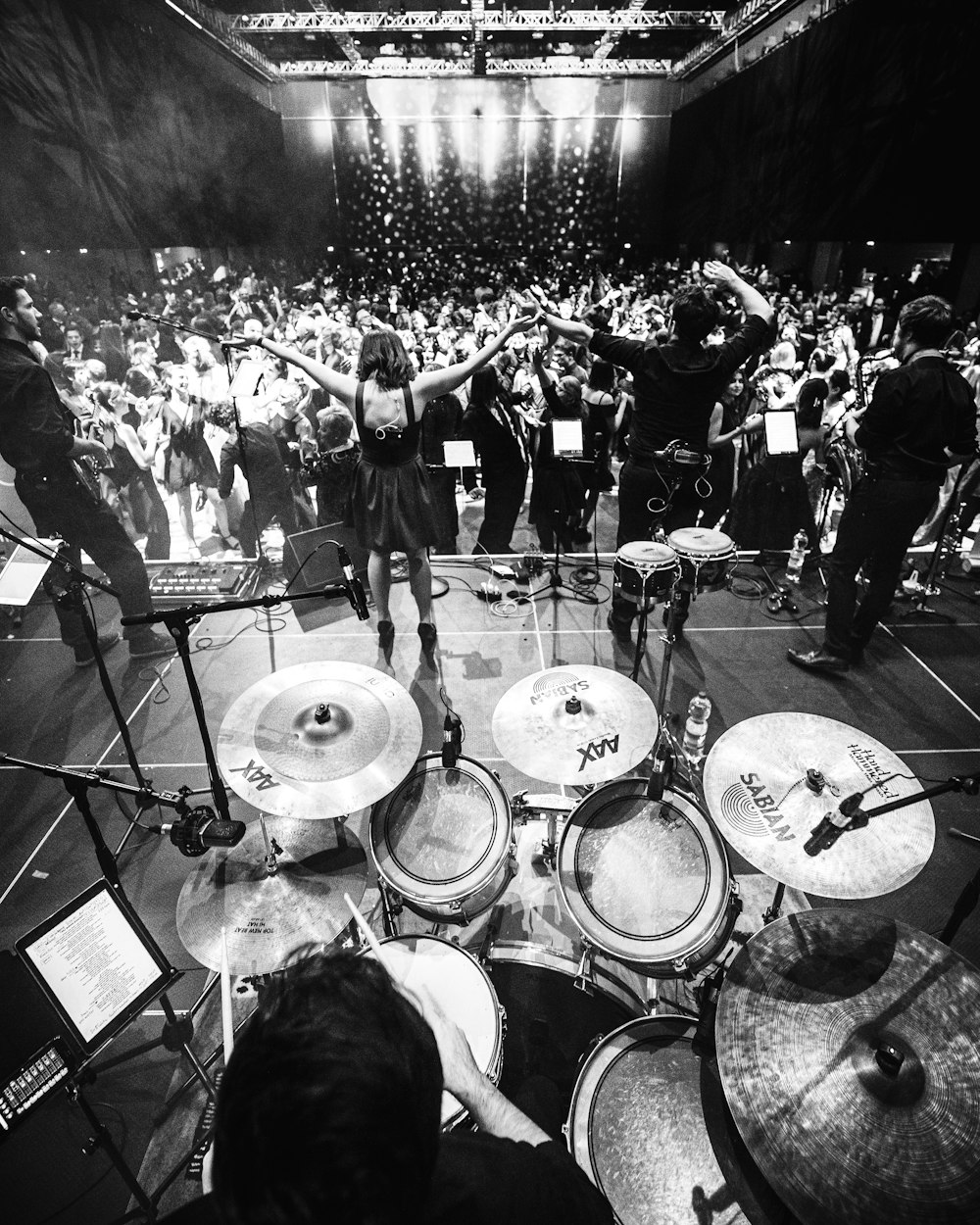 grayscale photo of band performing on stage