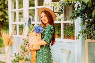 woman in green and white polka dot dress holding brown woven basket