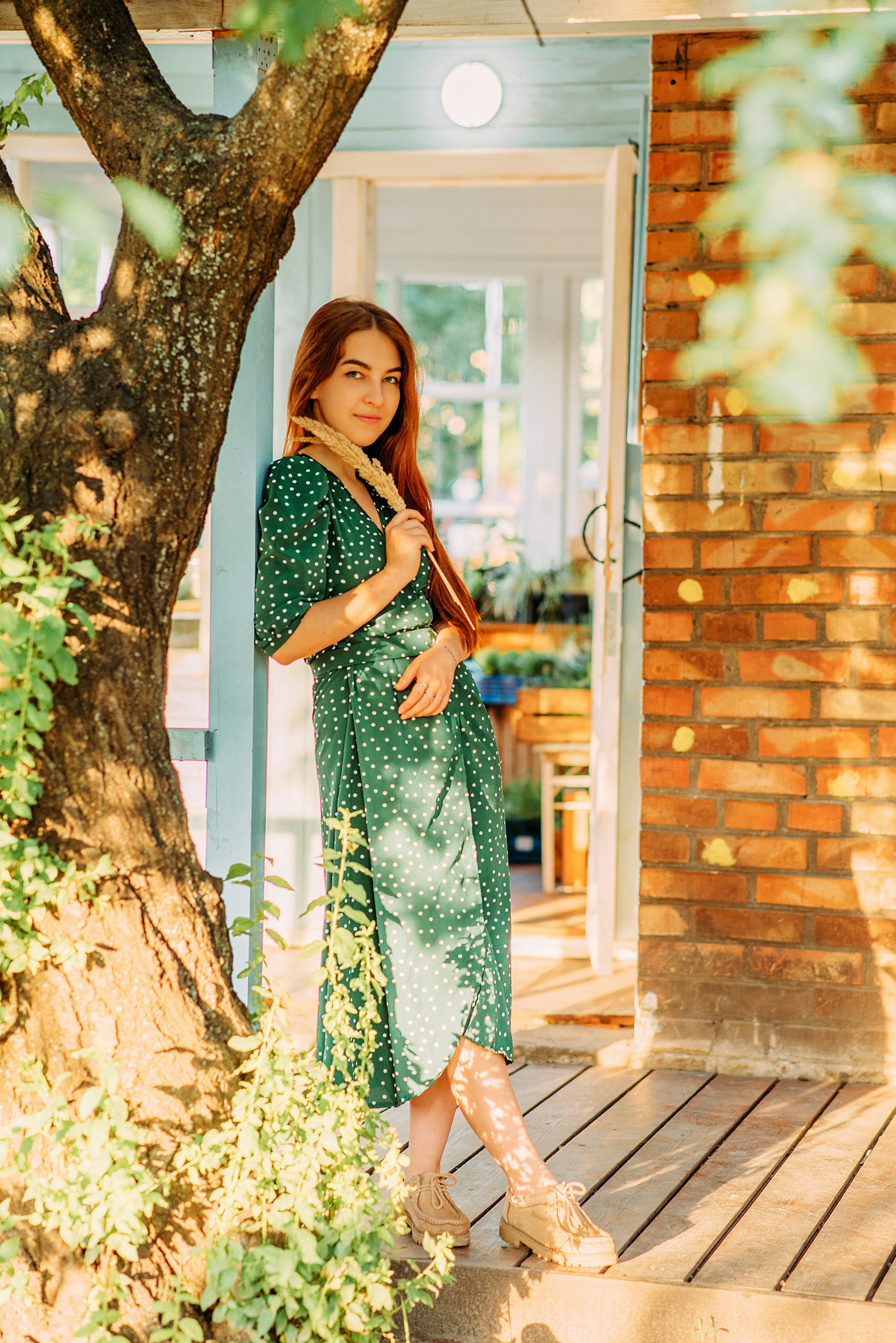 Woman in green dress standing beside brown tree during daytime photo  Free  Image on Unsplash