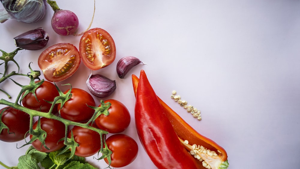 red chili and garlic on white surface