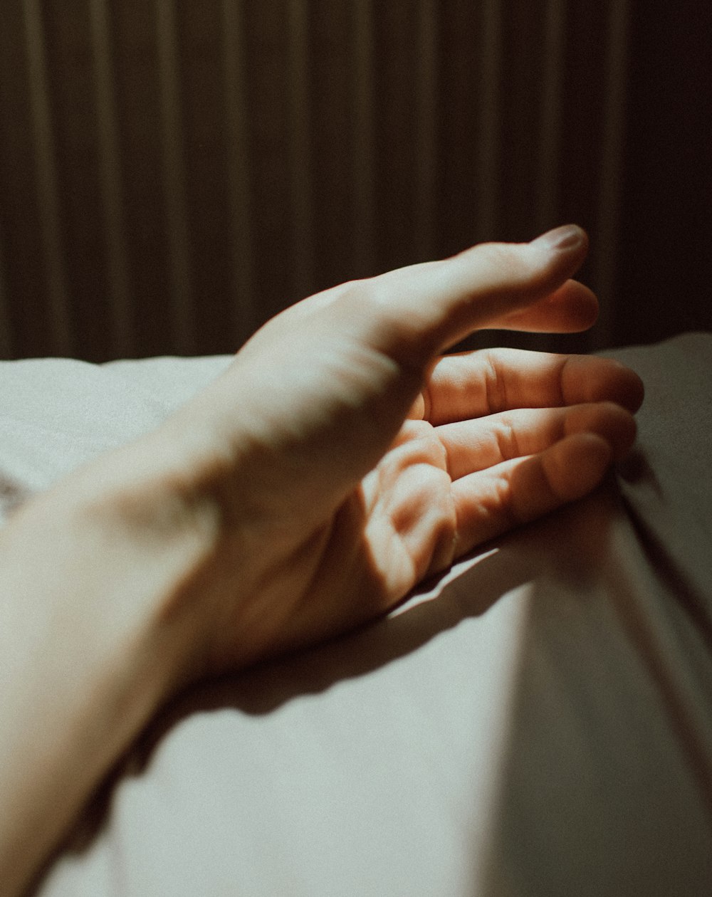 persons left hand on white textile