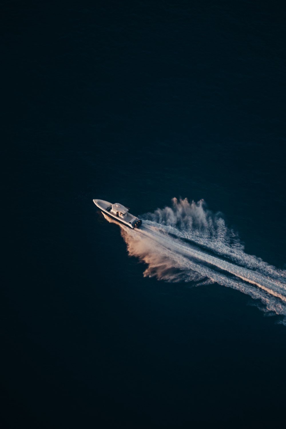 white and red jet plane in mid air during night time