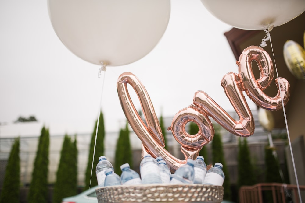 gold balloons on white wicker basket