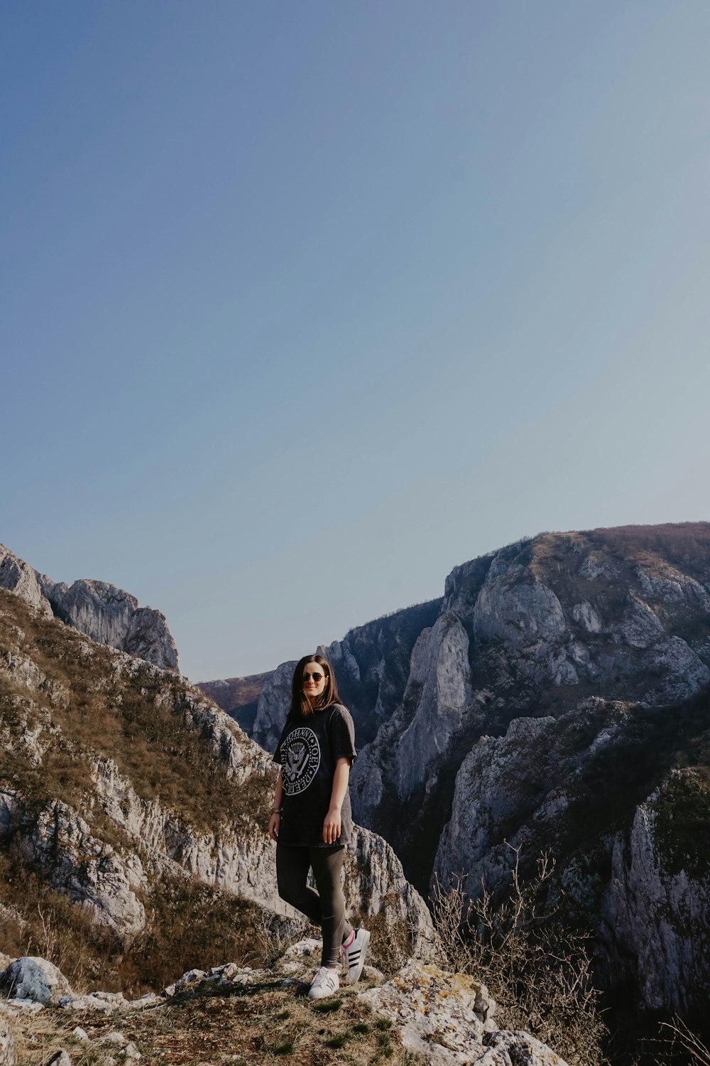 woman in black long sleeve shirt standing on rocky mountain during daytime