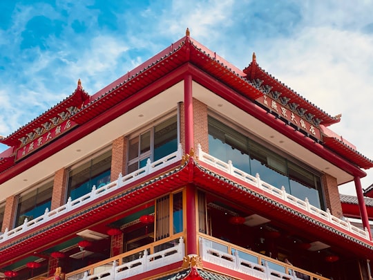 red and white concrete building under blue sky during daytime in Chinatown Incheon South Korea