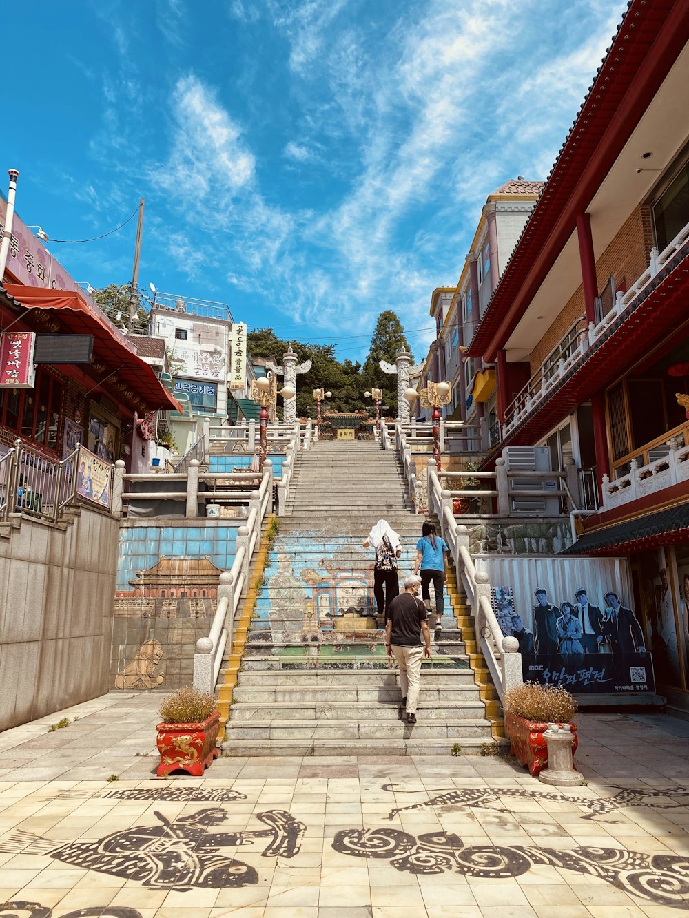 people walking on sidewalk near houses during daytime