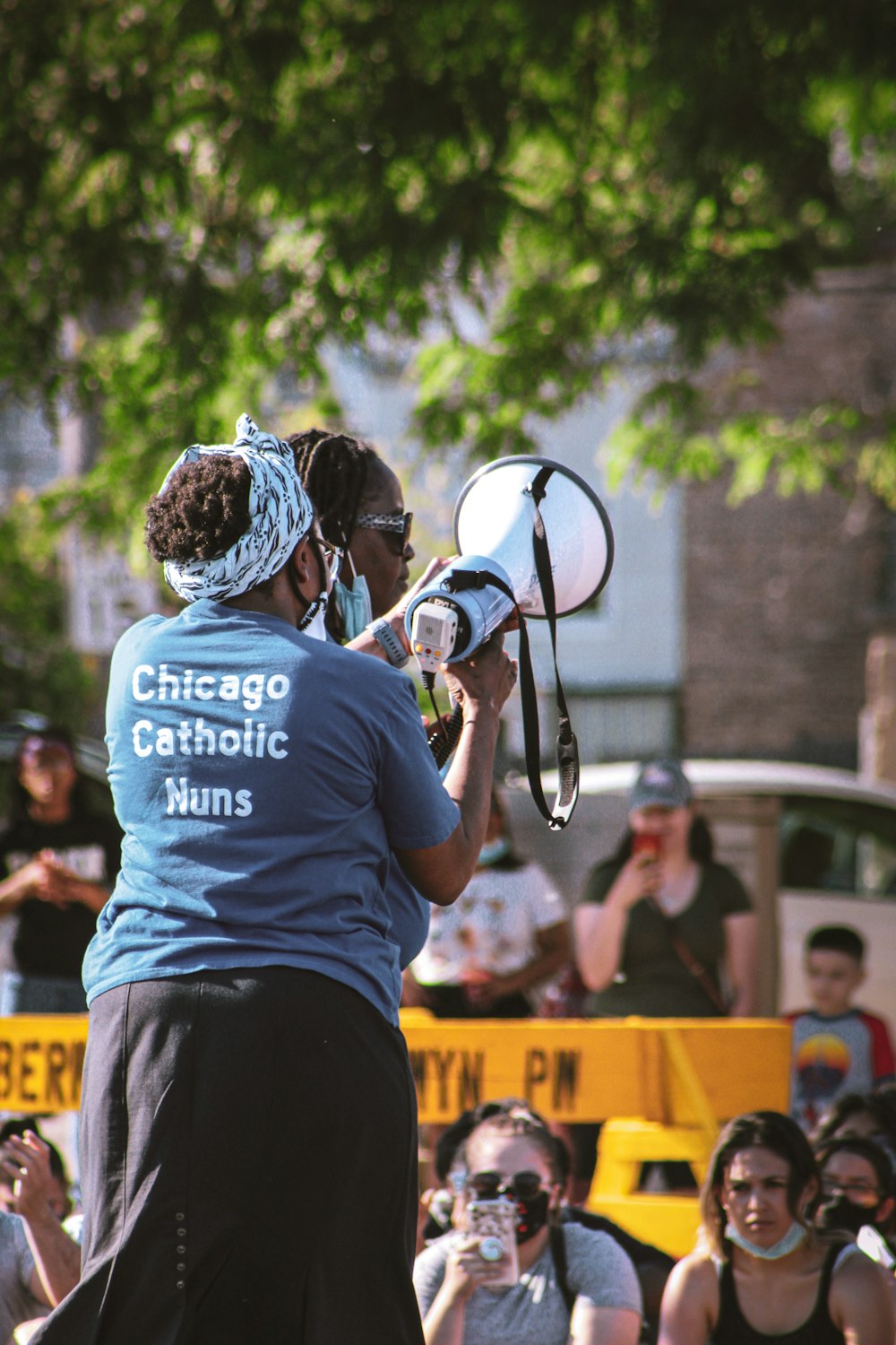 man in blue and white crew neck t-shirt playing drum during daytime