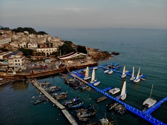 Visitors exploring the charming fishing village of Sisal with boats docked by the shore.
