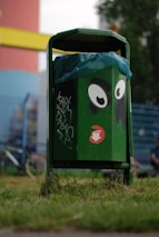 A vibrant green recycling bin with robotic sensors attached.