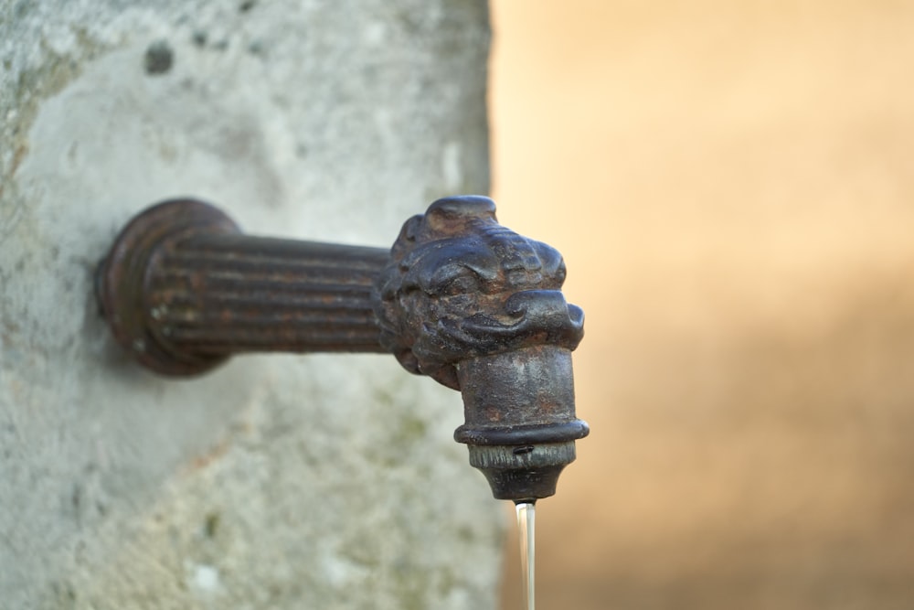 black metal pipe with water droplets