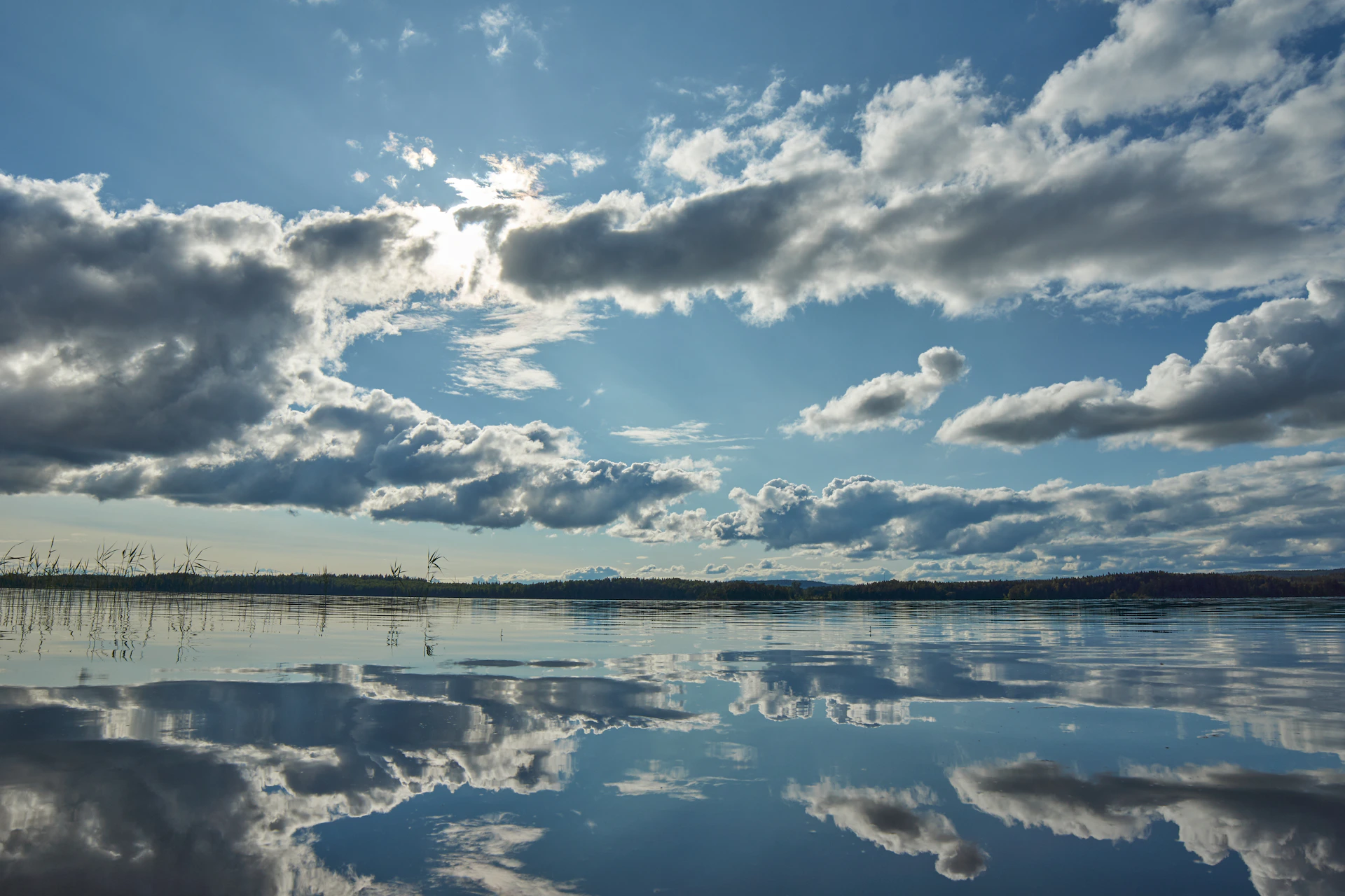 blue sky and white clouds over lake