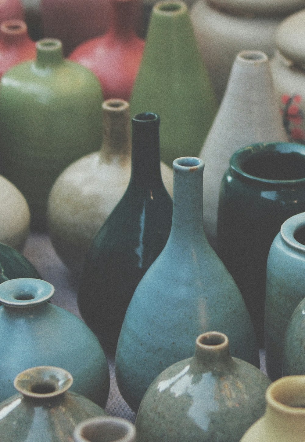 blue ceramic vase on white and red ceramic vase