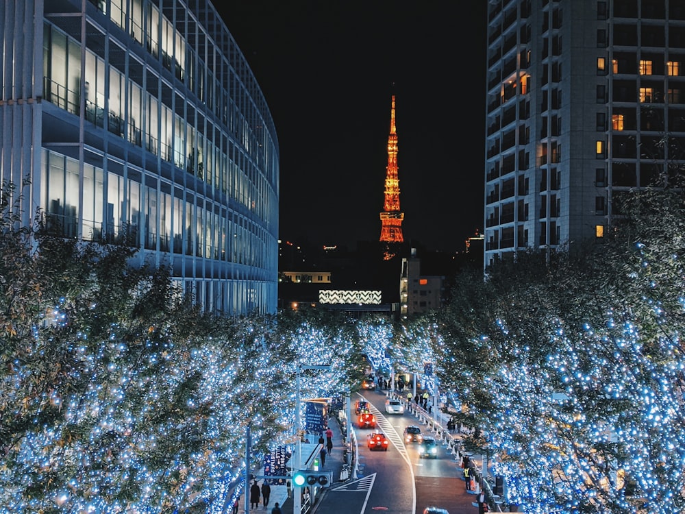 people walking on street near high rise building during nighttime