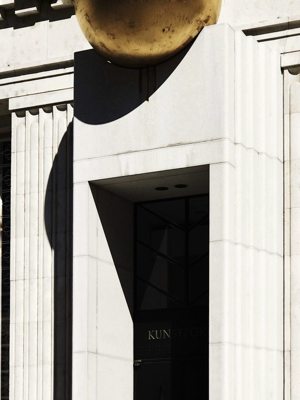 black wooden door on white concrete building