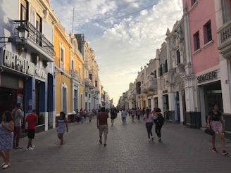 A colonial city street bustling with locals and tourists exploring.