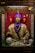 A fortune teller machine featuring a mannequin dressed in ornate clothing with a purple turban stands behind glass. The figure is adorned with jewelry and appears to hold a glowing crystal ball. The background is draped in red curtains, and there are decorative skulls on the table in front of the machine.