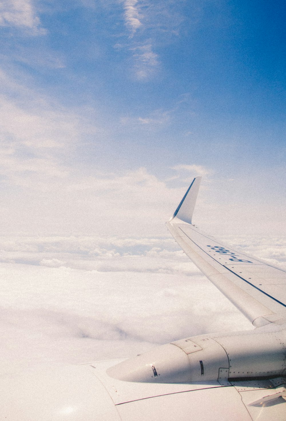 white airplane wing under blue sky during daytime