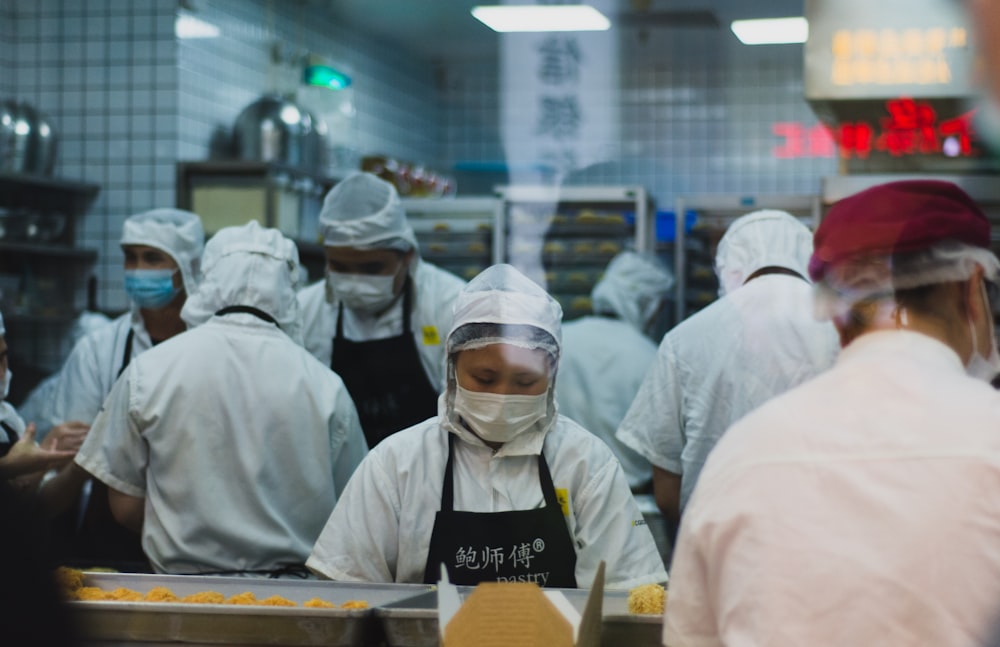 people in white hijab sitting at the table