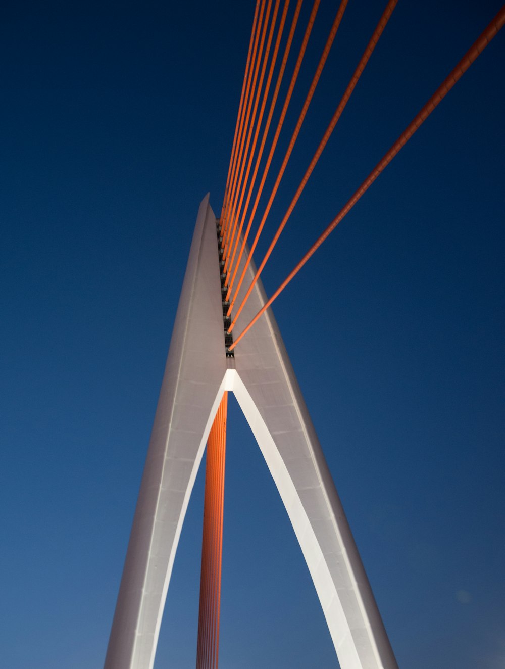white and orange bridge under blue sky