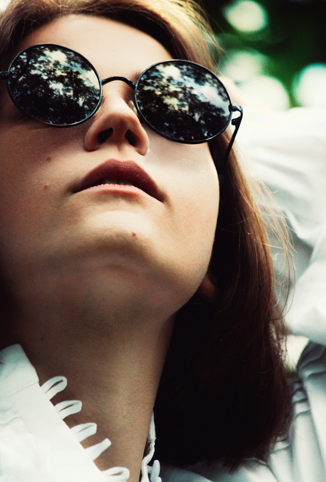 woman wearing black sunglasses and white shirt