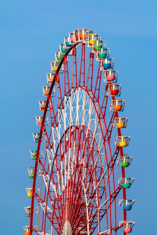 red and yellow ferris wheel under blue sky during daytime in Odaiba Japan