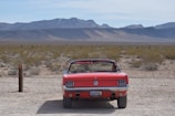 A sleek convertible parked near Saguaro National Park under a bright blue sky.