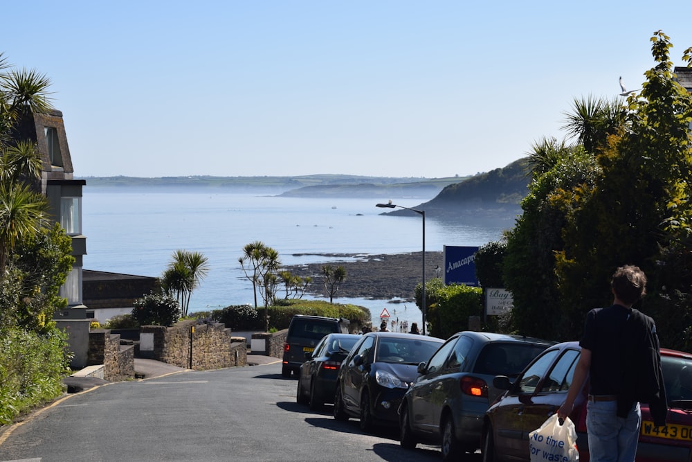 cars parked on parking lot near sea during daytime