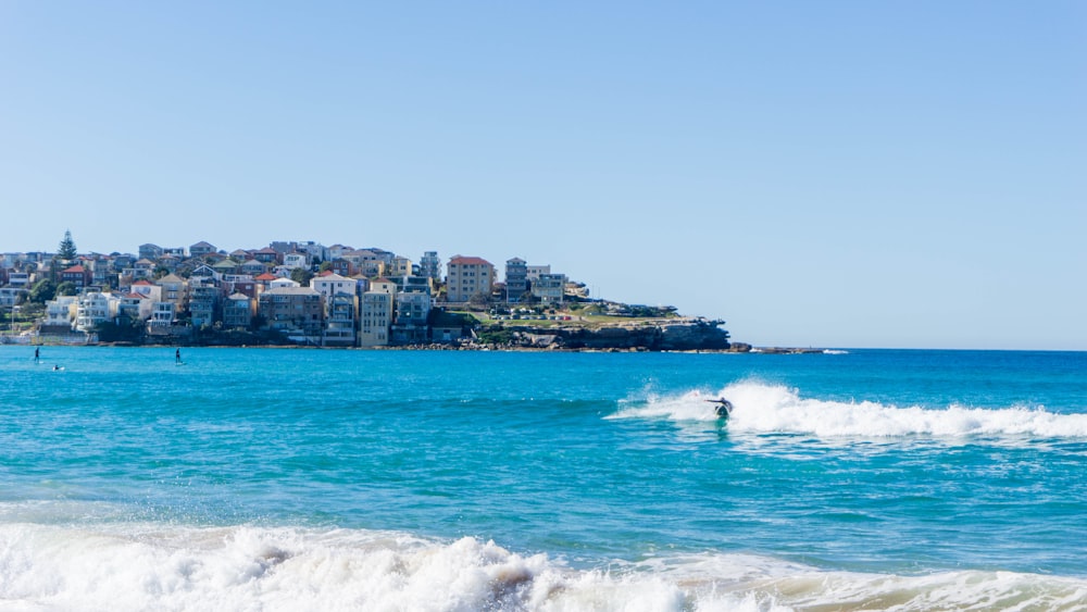 white and brown buildings near sea during daytime