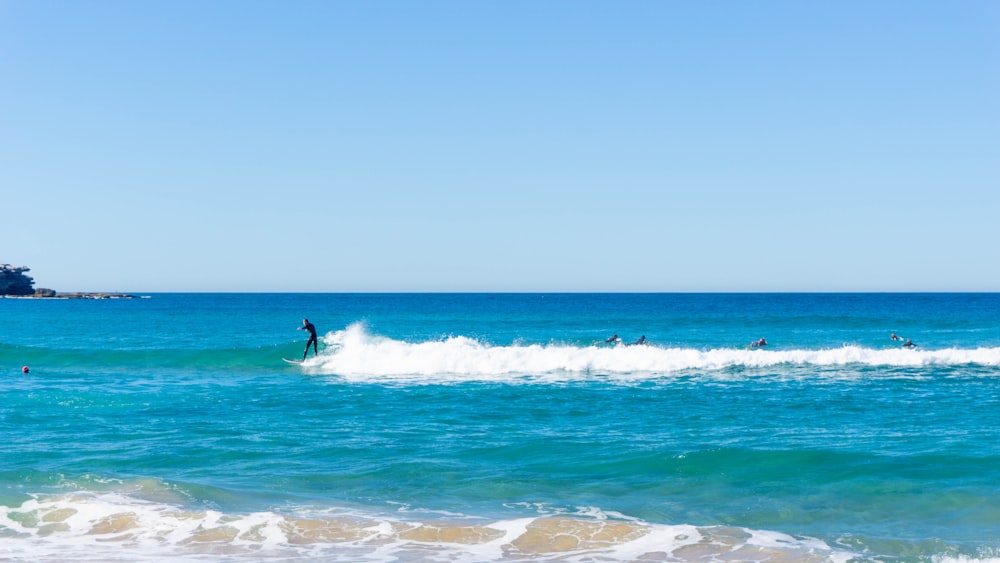 person surfing on sea waves during daytime