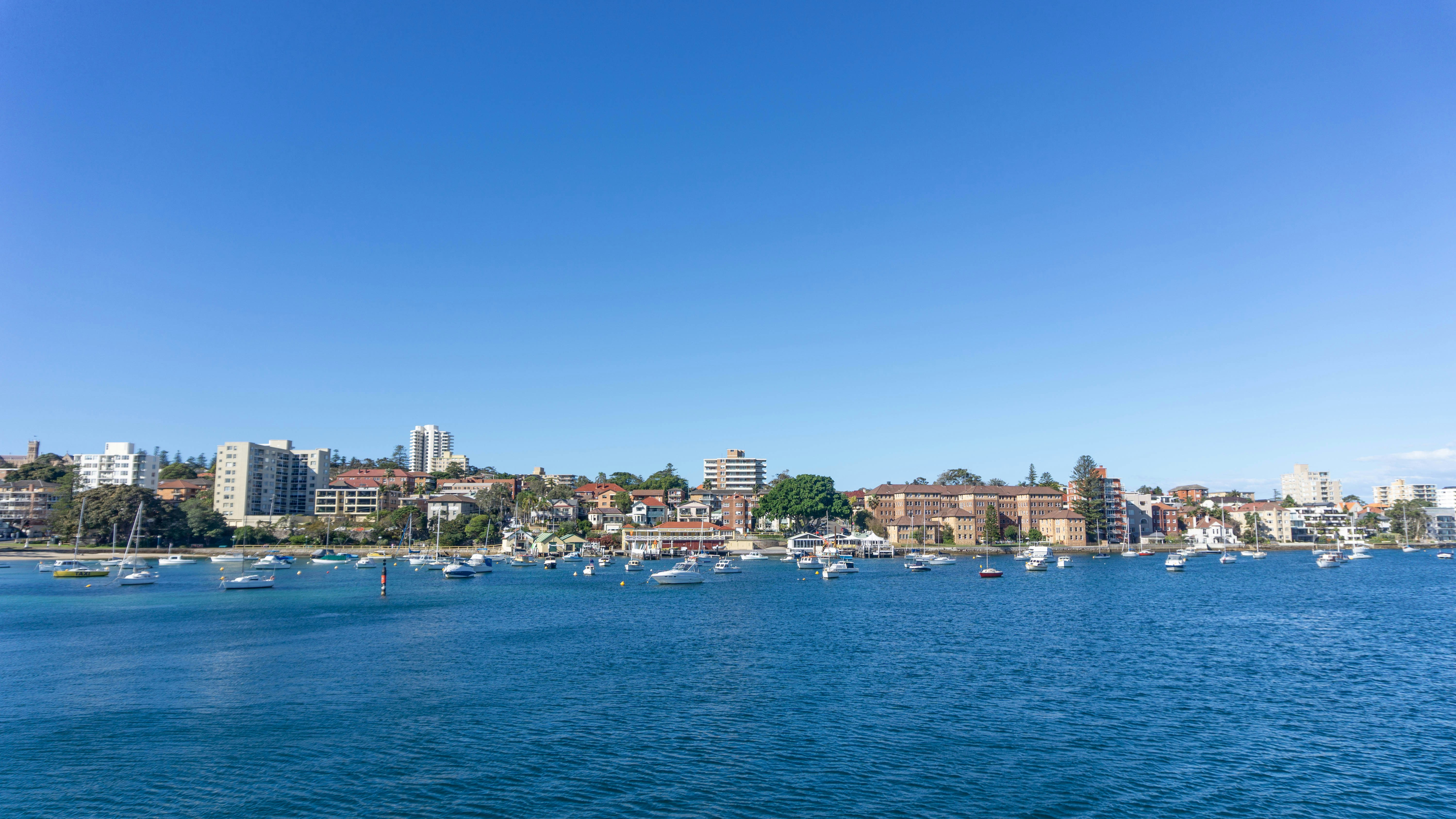 city skyline across blue sea under blue sky during daytime