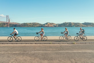 man in red shirt riding bicycle on road during daytime