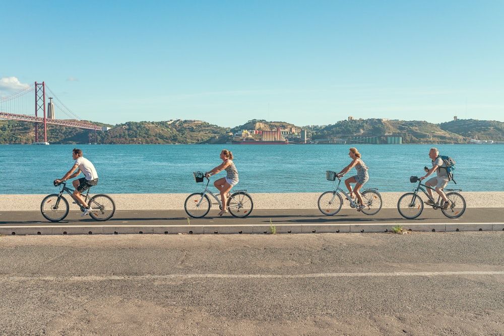 man in red shirt riding bicycle on road during daytime