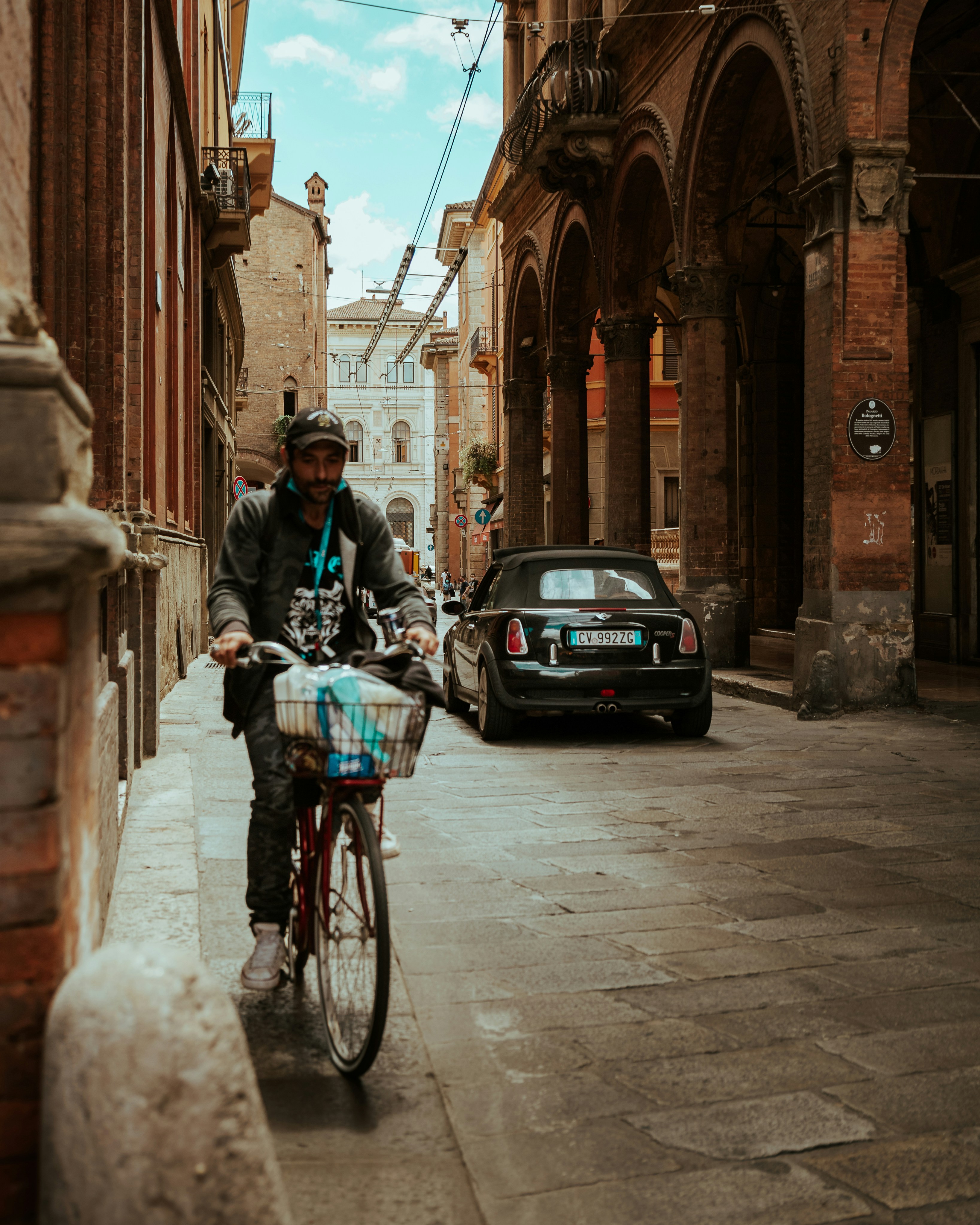 man in black jacket riding bicycle on street during daytime