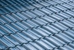Close-up of sleek modern roof tiles in cool gray tones with a matte finish.