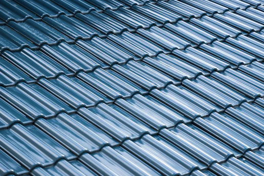 Close-up of a roof with new ceramic tiles under bright sunlight