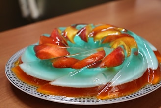 Refreshing lime mousse and vibrant gelatin desserts served in clear cups on a wooden table