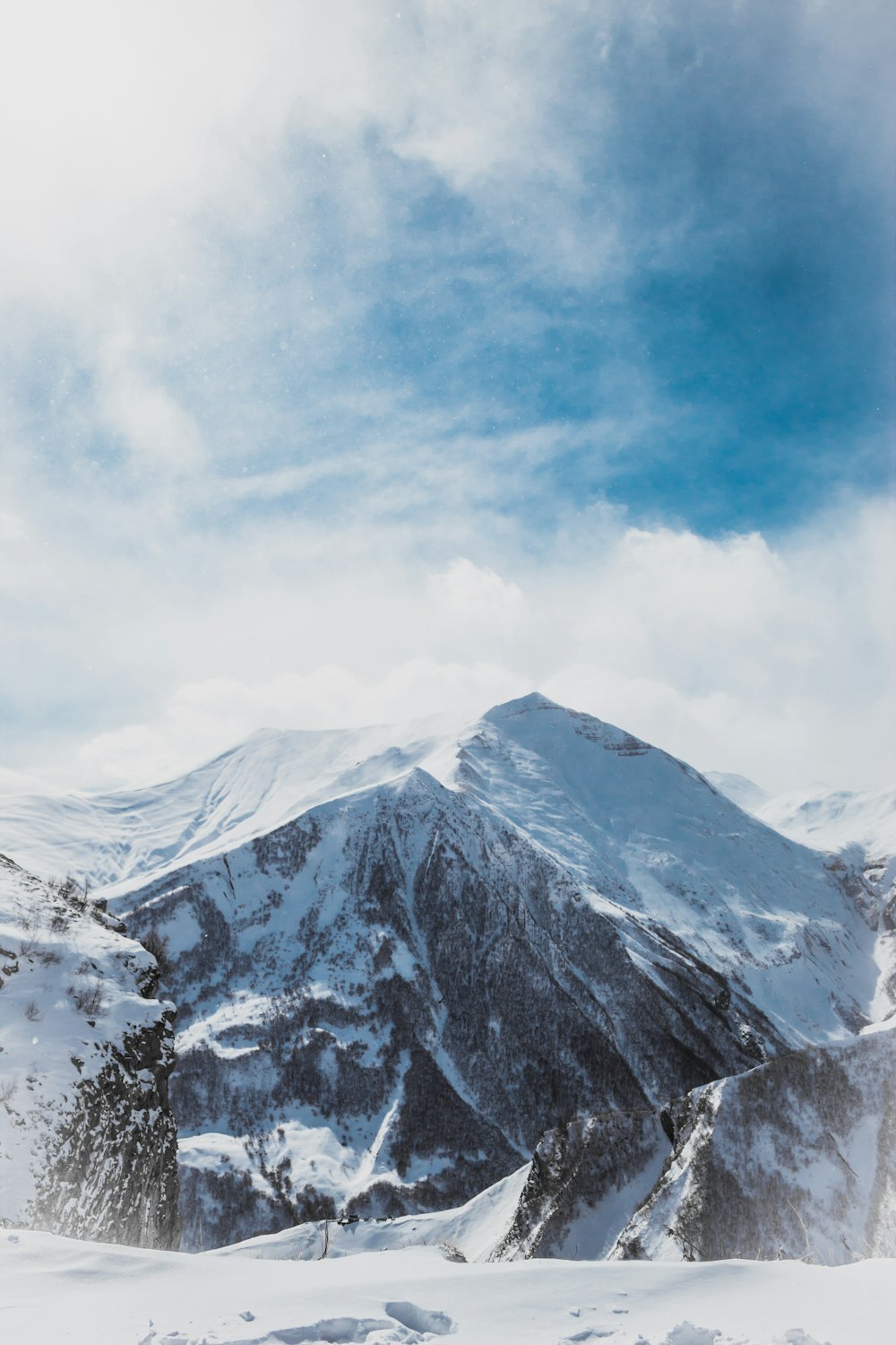 snow covered mountain under cloudy sky during daytime