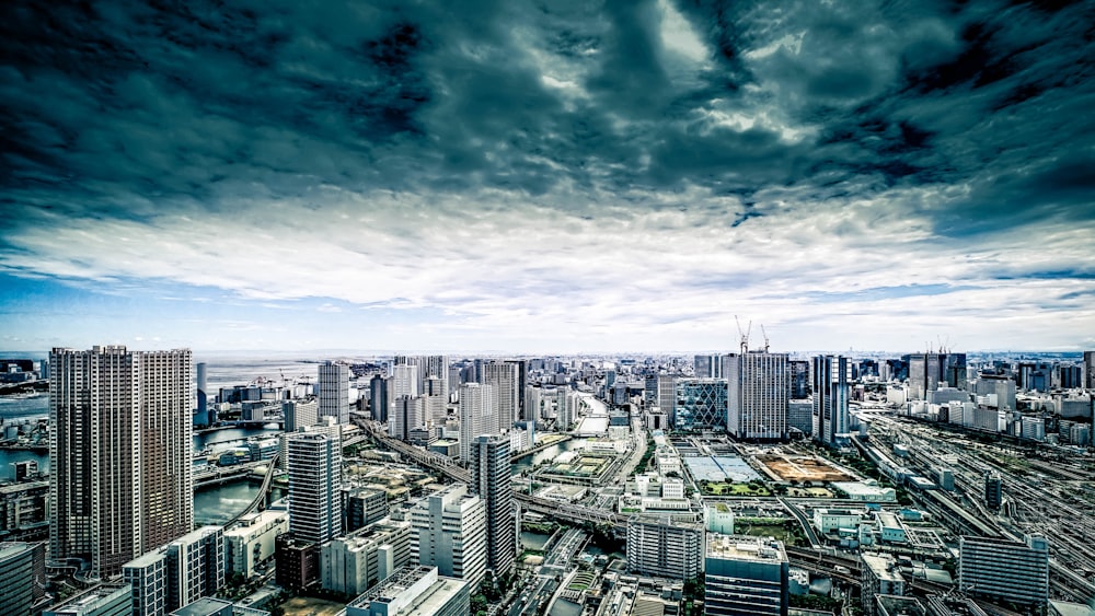 city skyline under blue and white sunny cloudy sky during daytime