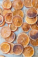 sliced orange fruits on white wooden table