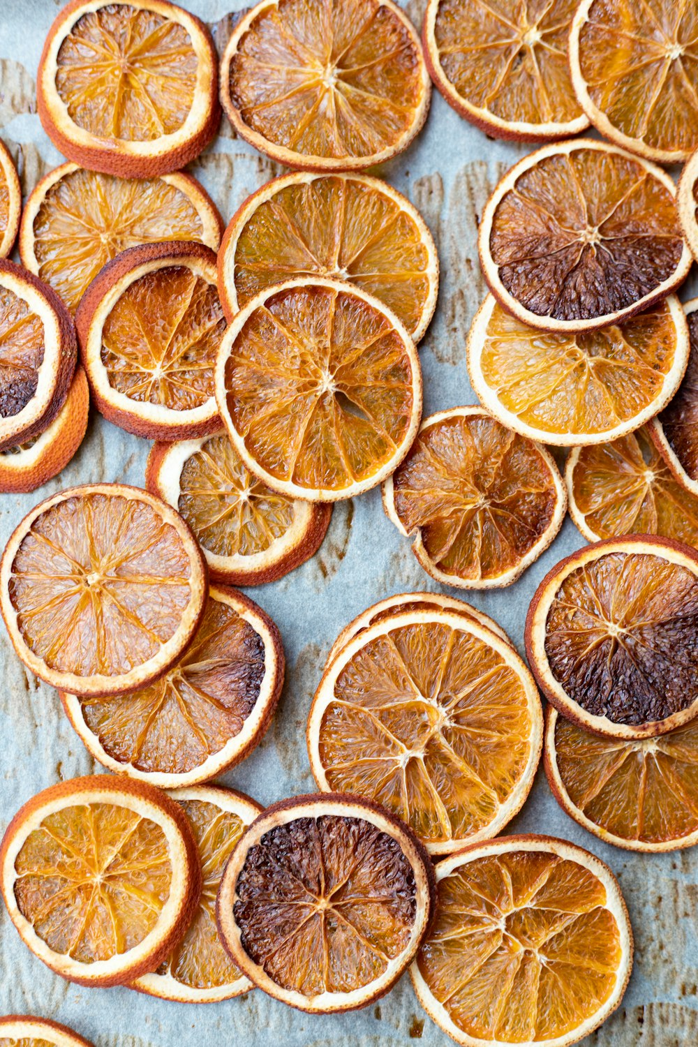 sliced orange fruits on white wooden table