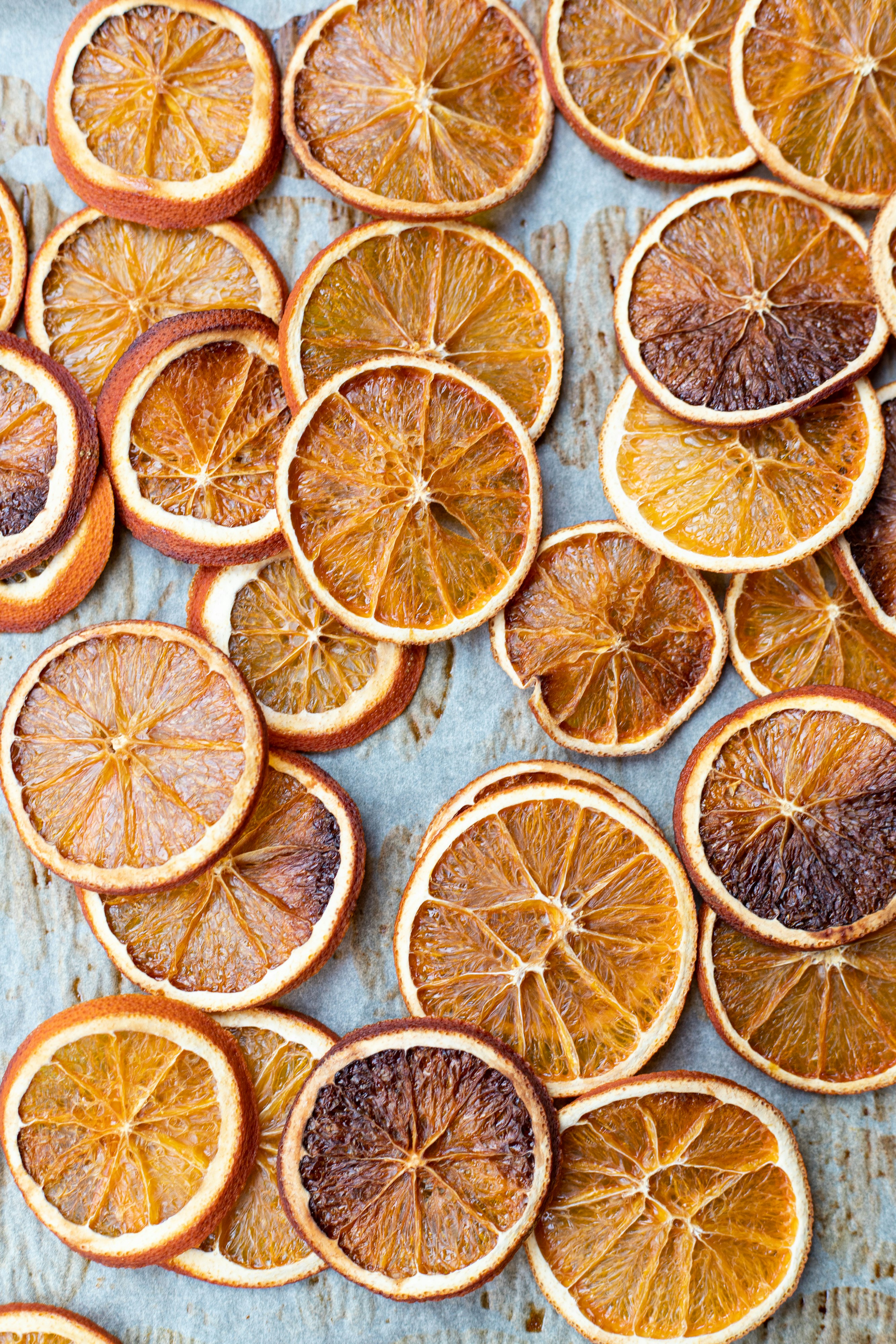 sliced orange fruits on white wooden table