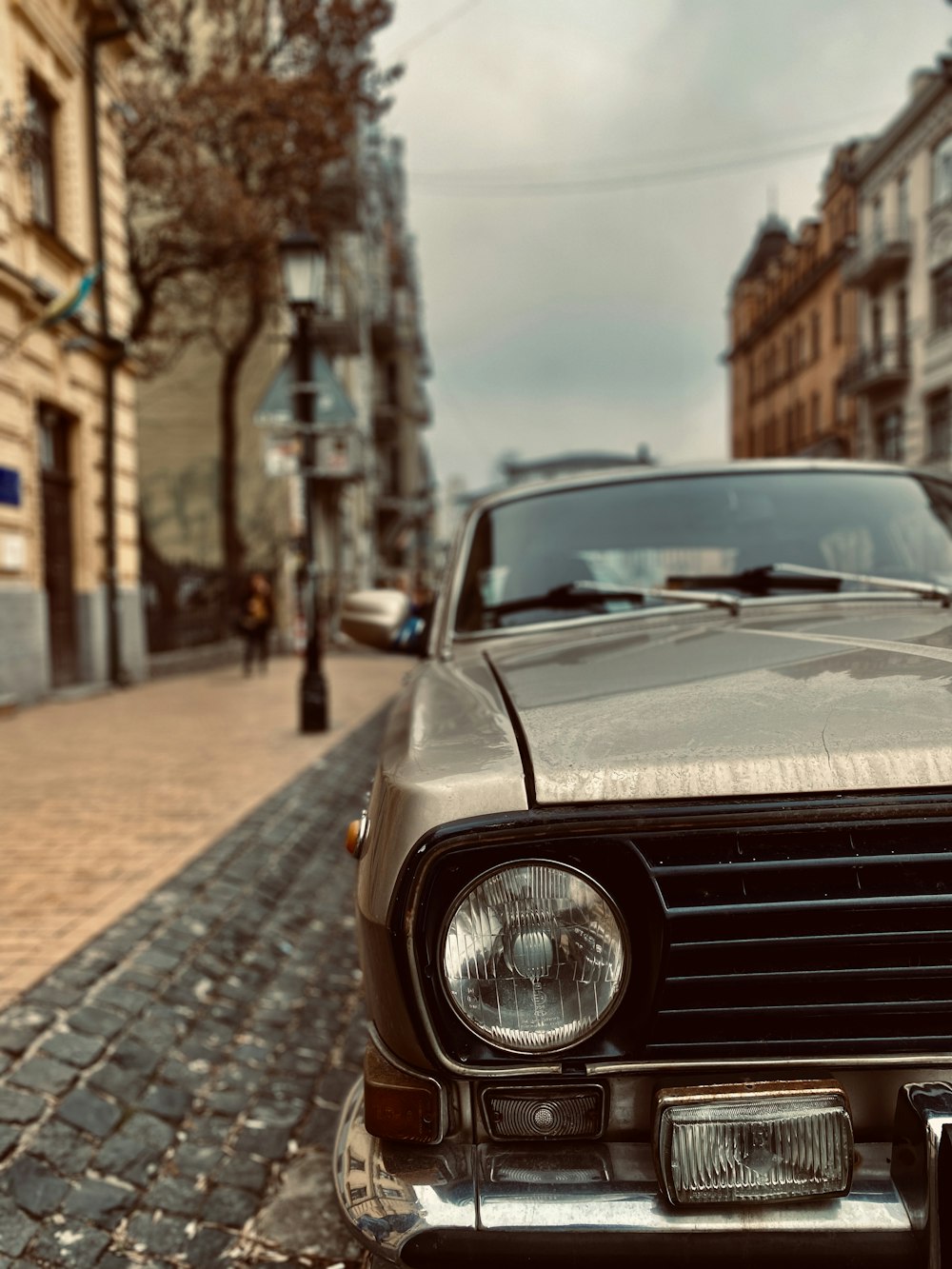 brown mercedes benz car parked on sidewalk during daytime