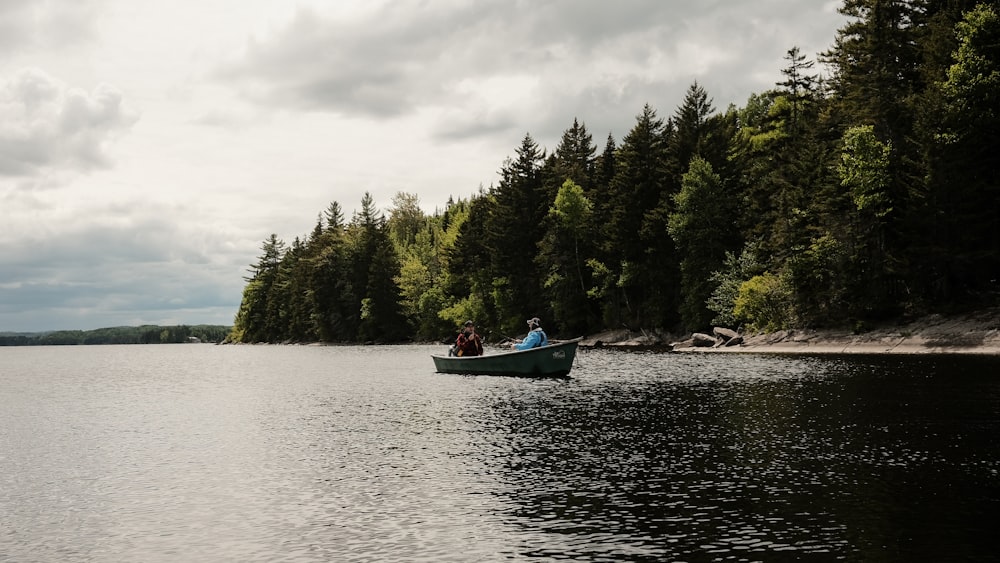 person riding on red boat on river during daytime