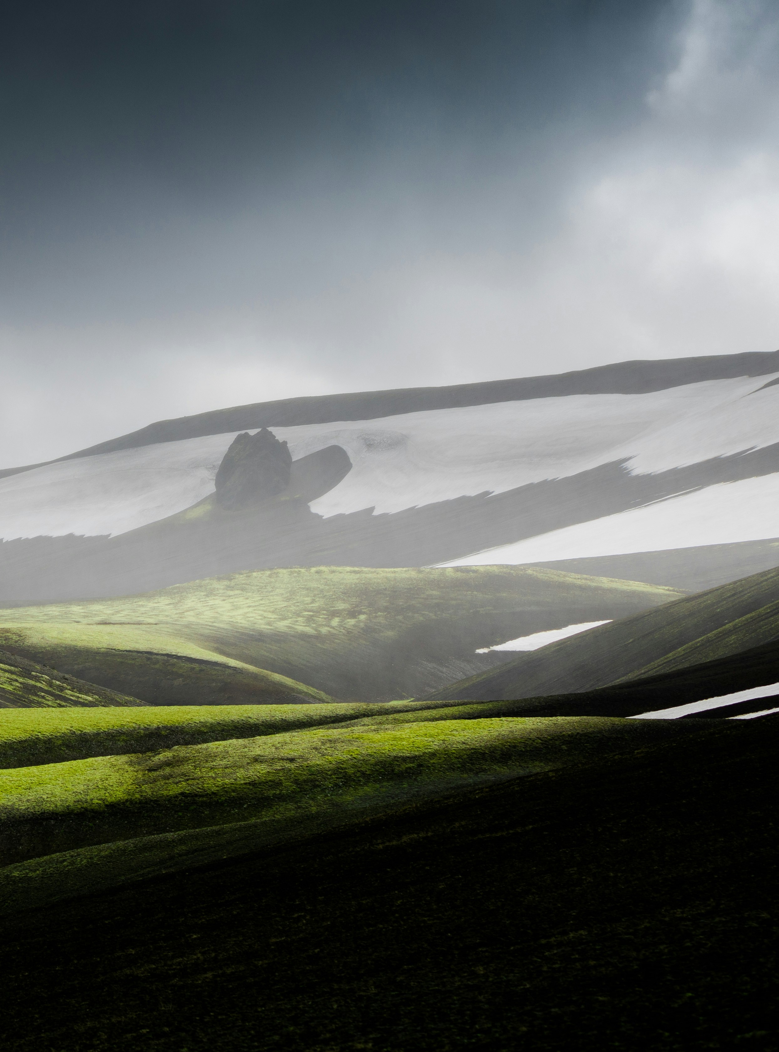 green grass field under white clouds