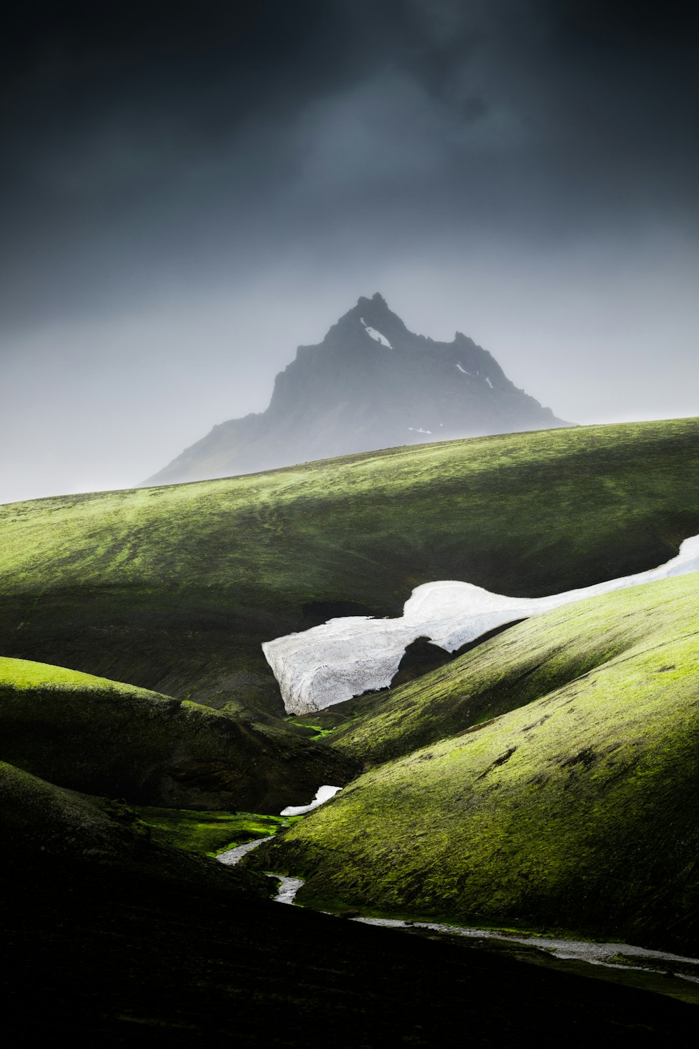 green grass field and mountain