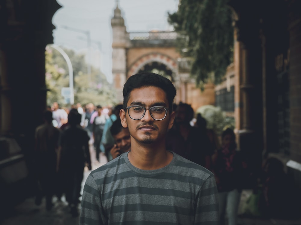 man in black and white striped crew neck shirt wearing black framed eyeglasses