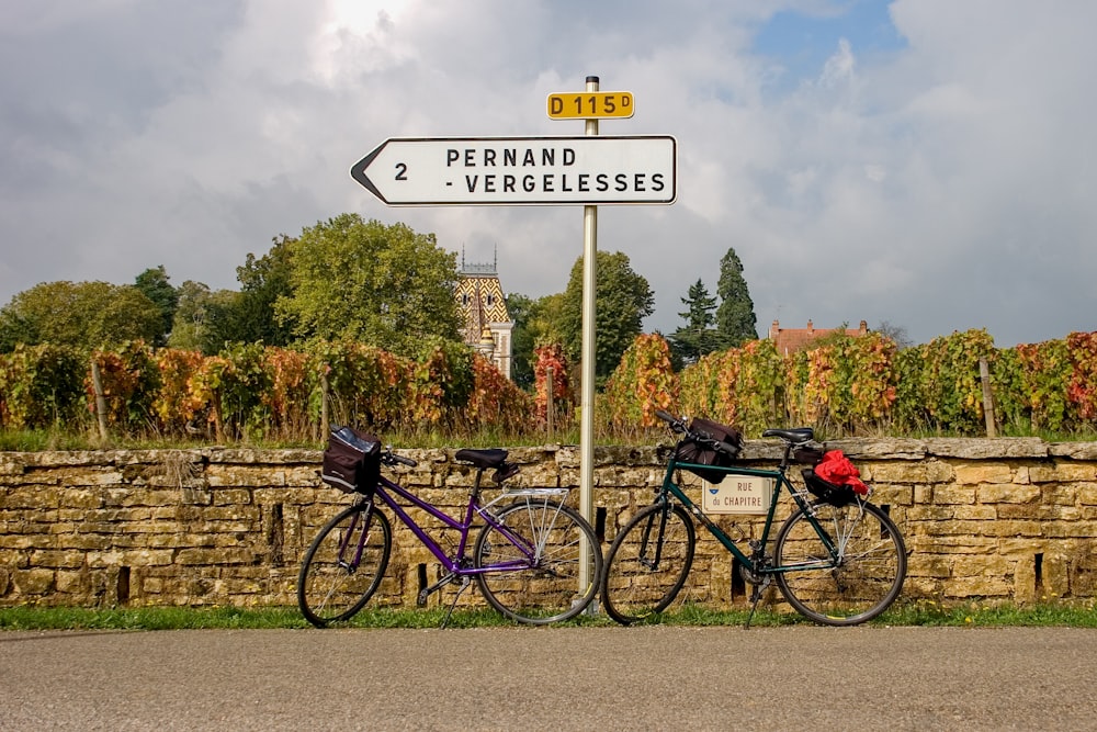 Vélo de ville violet et noir garé à côté du panneau de signalisation