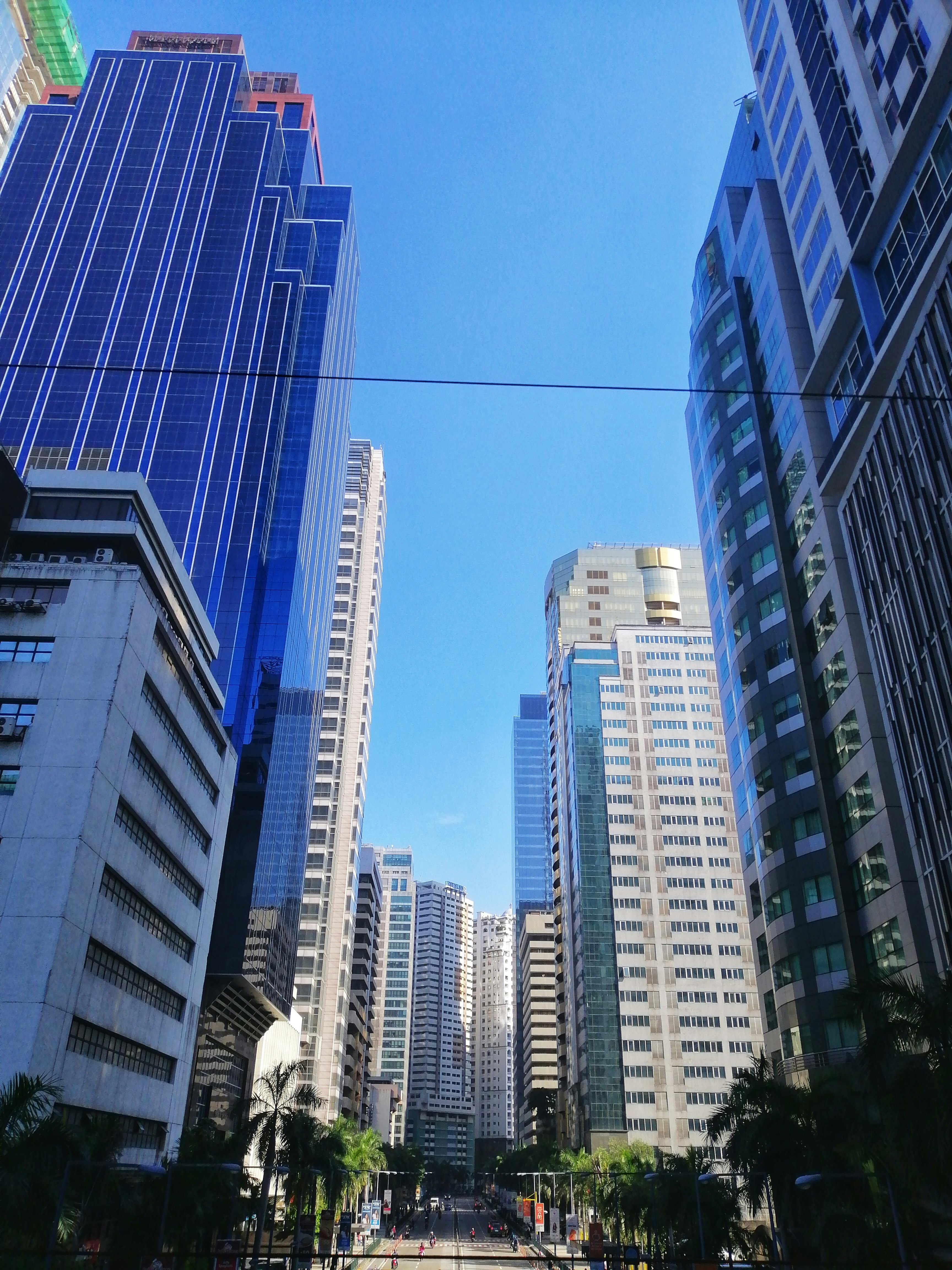 white and gray high rise buildings under blue sky during daytime