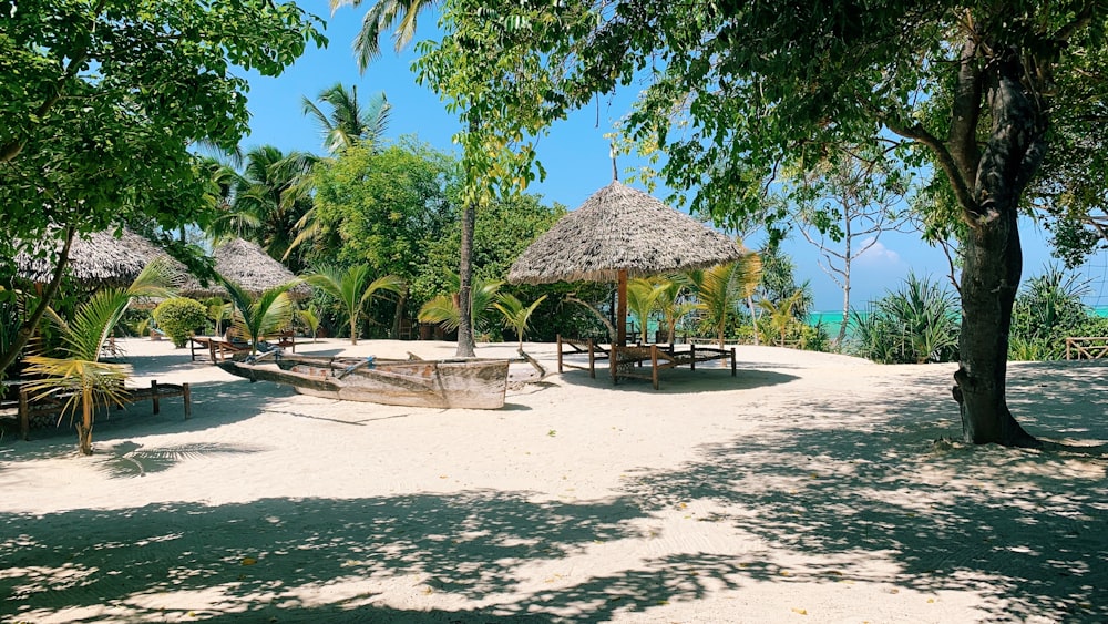 brown nipa hut on beach during daytime