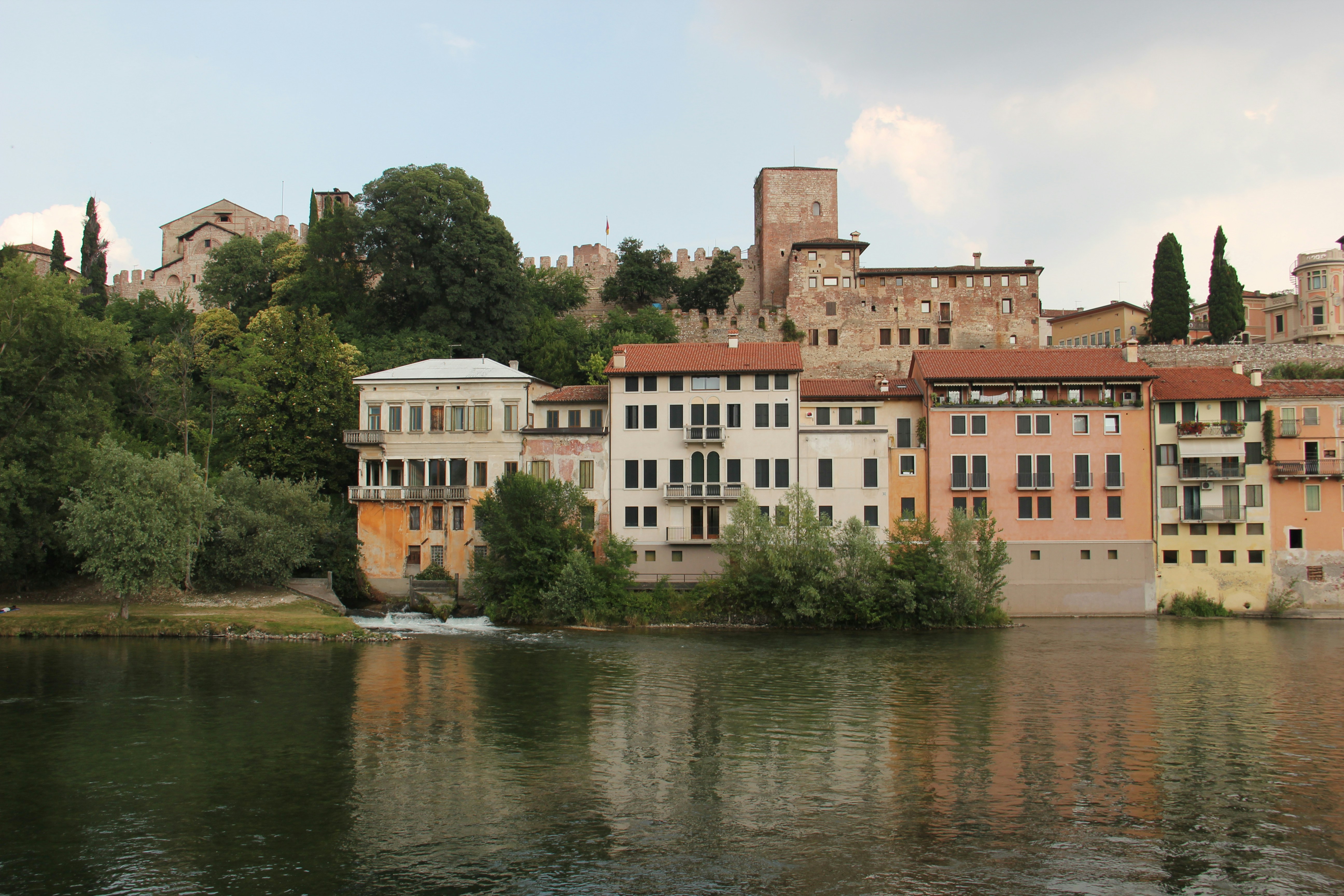 brown concrete building near body of water during daytime, 